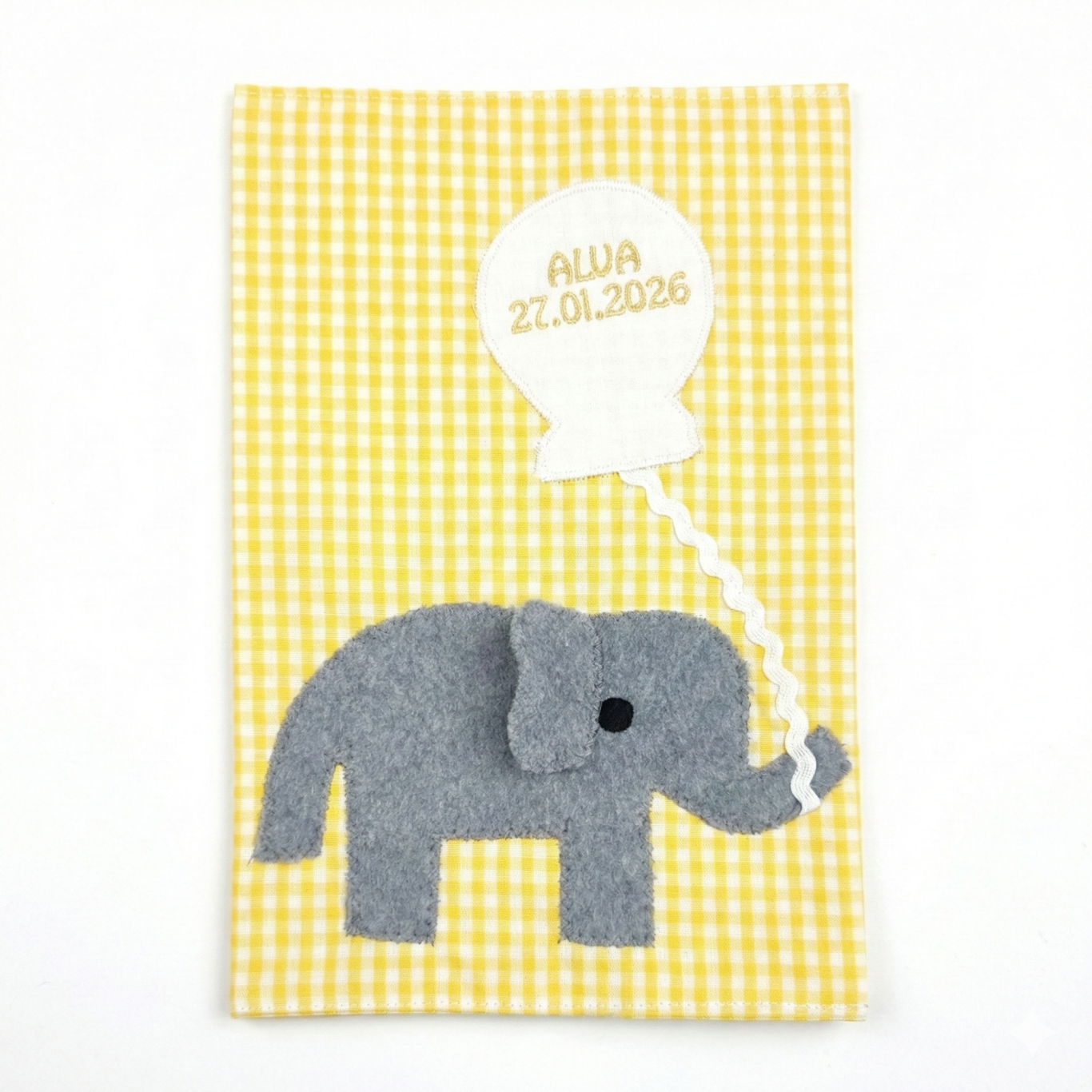 personalisierte U- Hefthülle mit grauem Elefant auf gelbweiß- kariertem Hintergrund mit Sprechblase.